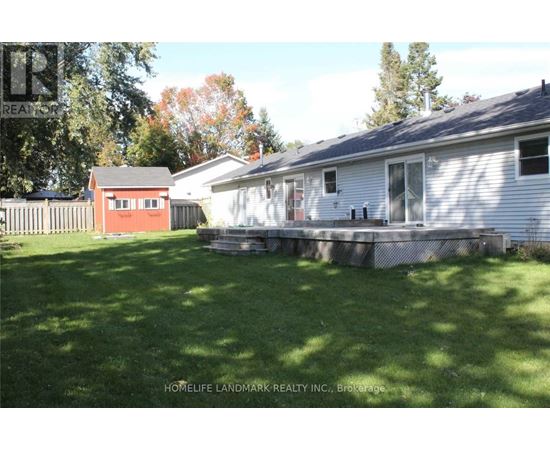 A house with a red shed in the backyard.