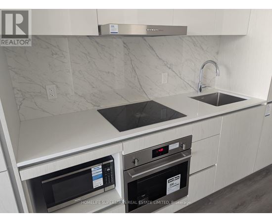 A modern kitchen with a stainless steel oven and microwave.