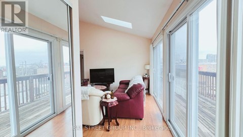 A living room with a red chair and a white sofa.