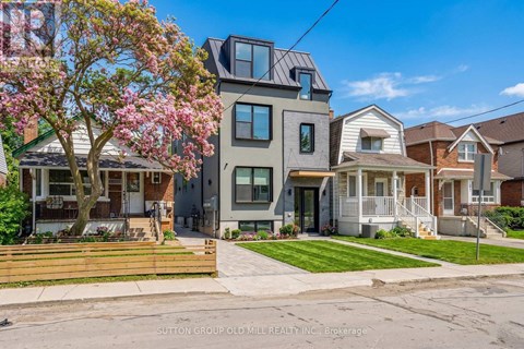 A row of houses with a tree in bloom in front of them.