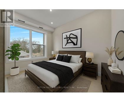 A bedroom with a large bed, a potted plant, and a mirror on the wall.