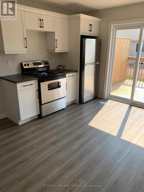A kitchen with white cabinets and a black stove top oven.