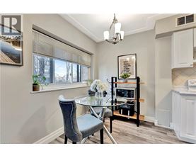 A dining room with a table and chairs.