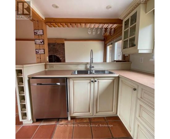 A large open living room with wood floors and a staircase.