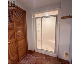 A room with a sliding door and a wooden door.