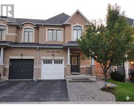A two-story house with a garage and a driveway.