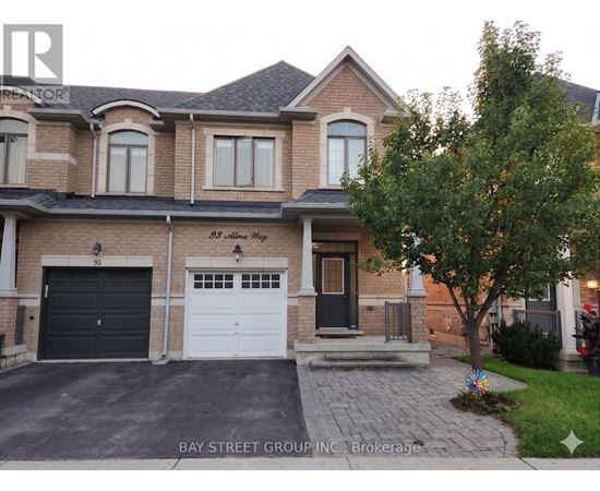 A two-story house with a garage and a driveway.