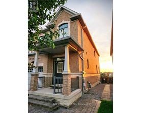 A house with a front porch and a sign that says "Bay Street Group Inc. Brokerage".