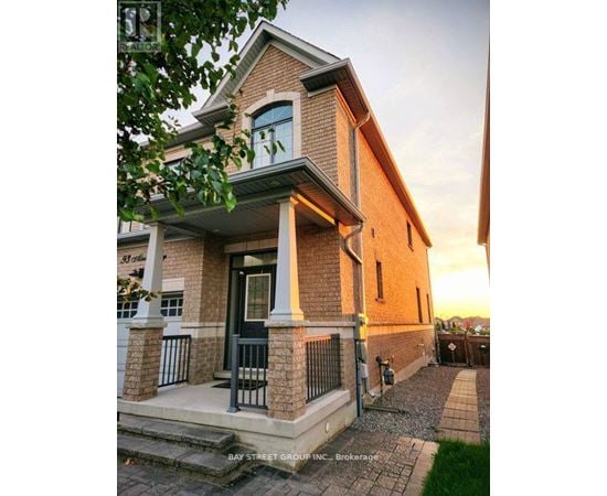 A house with a front porch and a sign that says "Bay Street Group Inc. Brokerage".