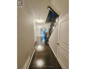 A long hallway with a staircase on the right side.