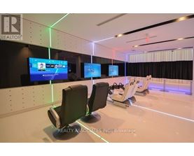 A conference room with a large screen and chairs.