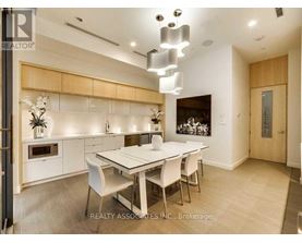 A modern dining room with a white table and chairs.