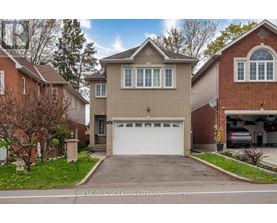 A house with a white garage door is for sale by Engel & Volkers Ottawa Brokerage.