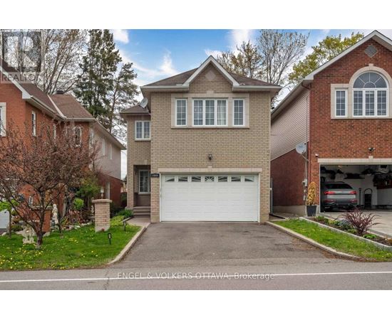 A house with a white garage door is for sale by Engel & Volkers Ottawa Brokerage.