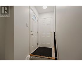A white door with a black mat in front of it.