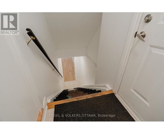 A hallway with a staircase leading to the second floor.