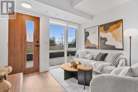 A modern living room with a grey couch and a wooden door.