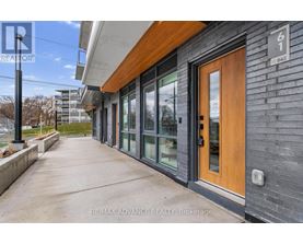 A building with a brown door and a sign that says RE/MAX ADVANCE REALTY, Brokerage.
