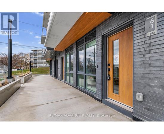 A building with a brown door and a sign that says RE/MAX ADVANCE REALTY, Brokerage.