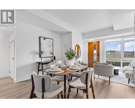 A dining room with a table set for two and chairs around it.