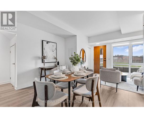 A dining room with a table set for two and chairs around it.