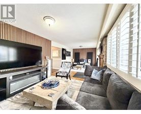 A living room with a flat screen TV and a wooden coffee table.