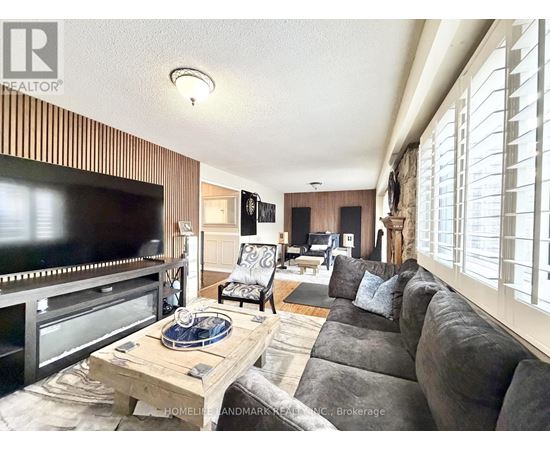 A living room with a flat screen TV and a wooden coffee table.