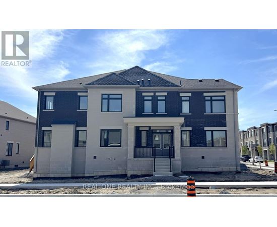 A modern two-story house with a black and white exterior is under construction.
