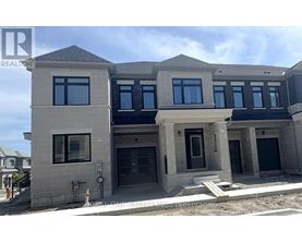 A modern two-story house with a flat roof and large windows.