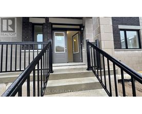 A set of stairs with a black railing leading to a door with a glass window.