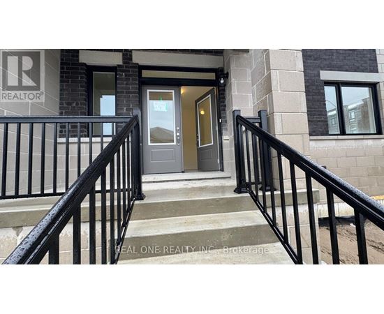 A set of stairs with a black railing leading to a door with a glass window.