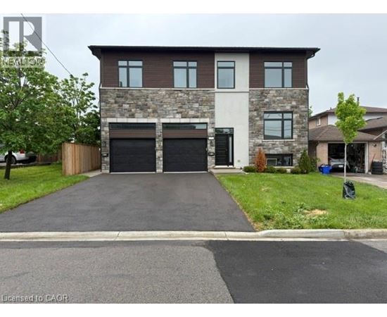 A two-story house with a garage is situated on a street.