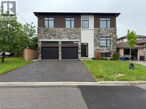A two-story house with a garage is situated on a street.