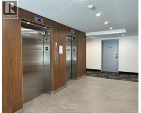 A hallway with elevators numbered 12, 13, and 14.