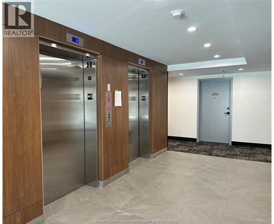 A hallway with elevators numbered 12, 13, and 14.