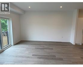 A room with a wooden floor and white walls.