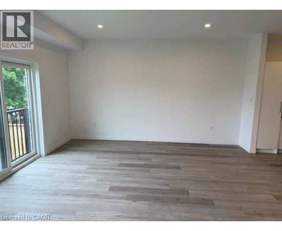 A room with a wooden floor and white walls.