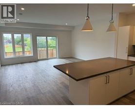 A spacious kitchen with a large island and pendant lights.
