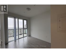 A room with a sliding glass door leading to a balcony.