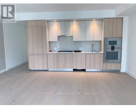 A kitchen with wooden cabinets and a stove top oven.