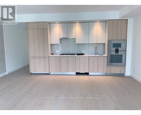 A kitchen with wooden cabinets and a stove top oven.