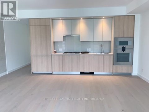A kitchen with wooden cabinets and a stove top oven.