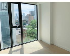 A room with a view of the city through large windows.