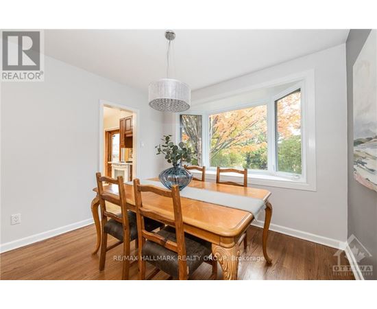 A dining room with a wooden table and chairs.