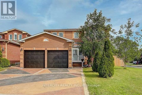 A house with a brown roof and two garage doors is for sale.