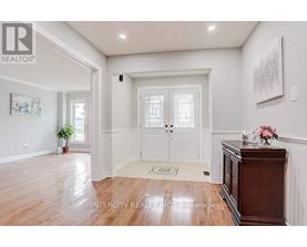 A hallway with a wooden floor and white walls.