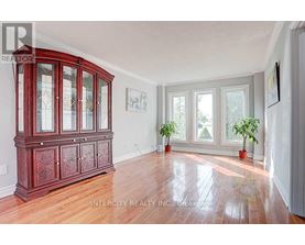 A room with a wooden floor and a large wooden cabinet.
