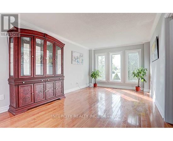 A room with a wooden floor and a large wooden cabinet.