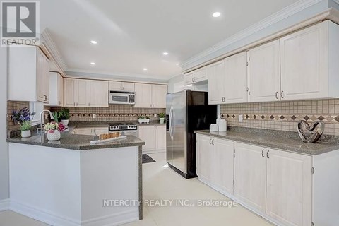 A kitchen with white cabinets and a granite countertop.