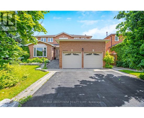 A house with a driveway and garage doors is for sale.